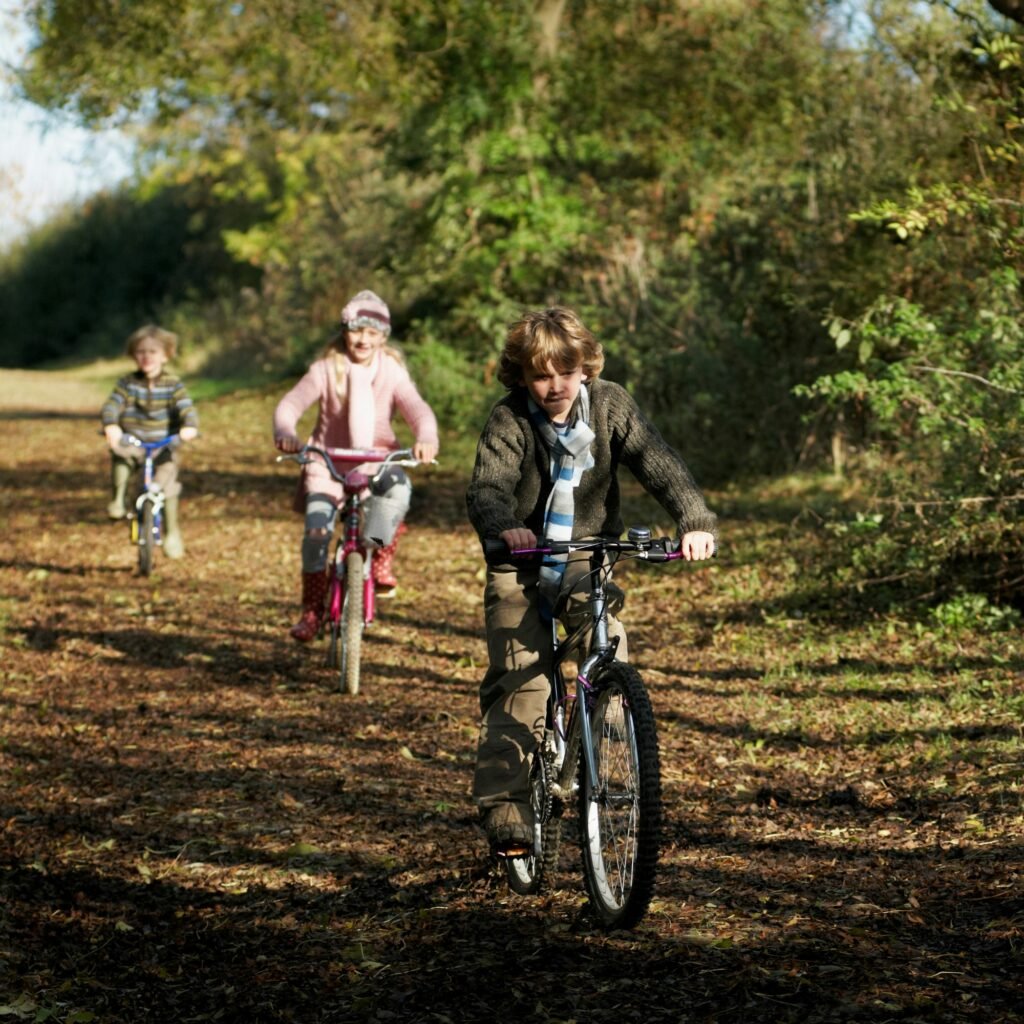 Children riding bikes in countryside